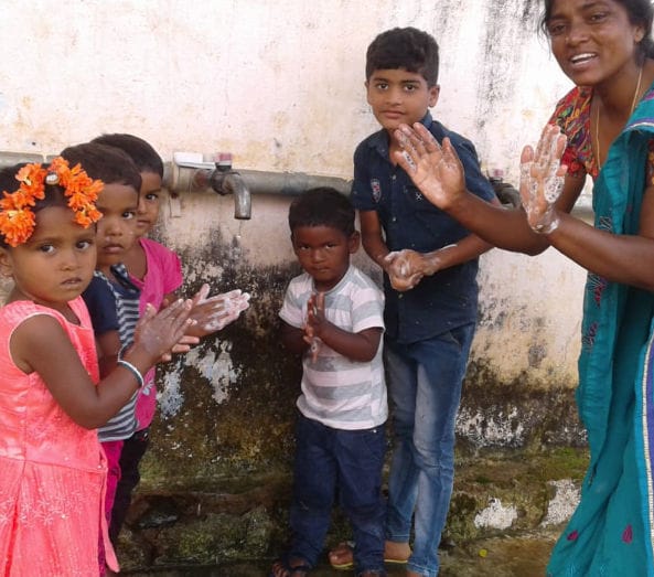 lady washing hands with children
